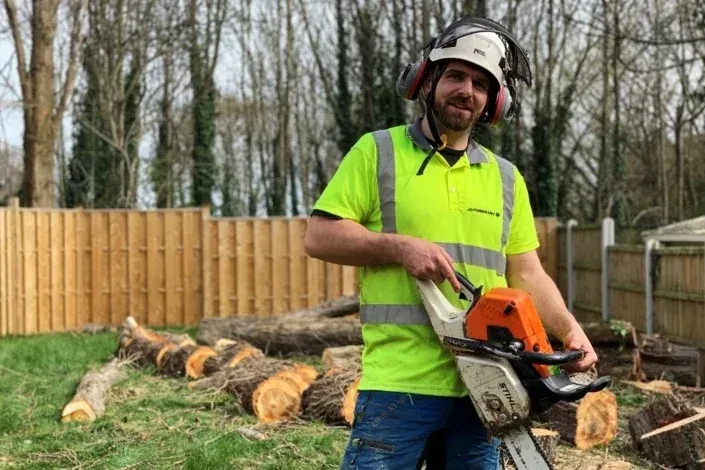 Qualified Sheffield arborist with a chainsaw on a tree removal job